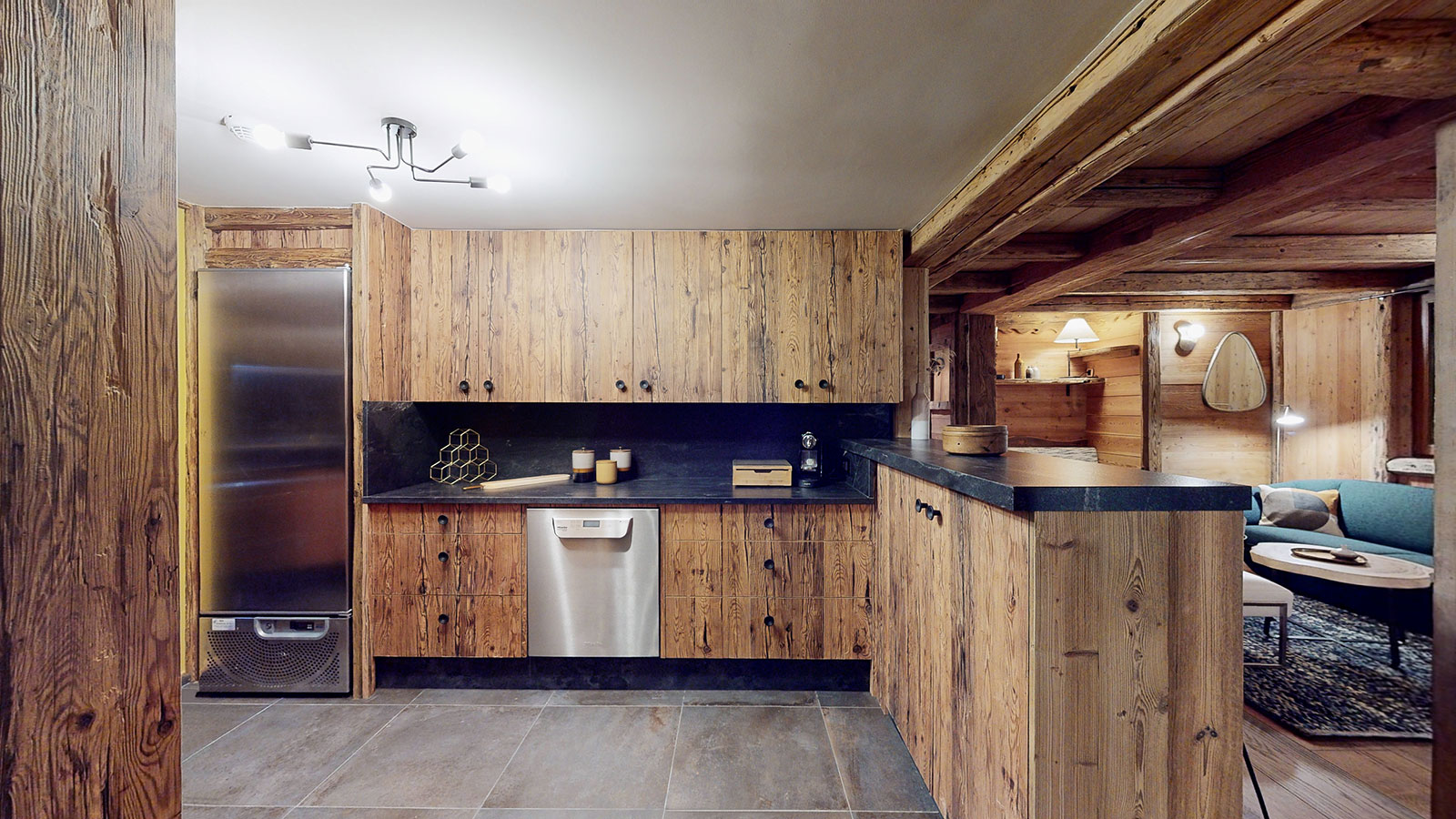 Fully equipped open-plan kitchen at Chalet La Marsa, opening onto the living room