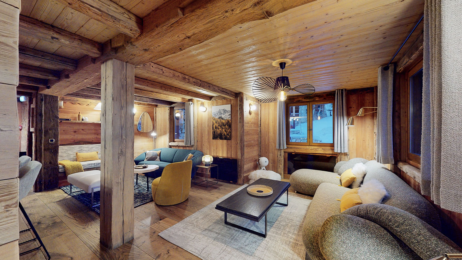 Third living area at Chalet La Marsa, comfortable sofas and alpine decor